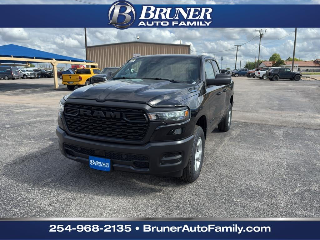 2026 RAM Ram 1500 RAM 1500 TRADESMAN QUAD CAB 4X4 6'4' BOX in Diamond Black Crystal Pearl-Coat Exterior Paint — front three-quarter view