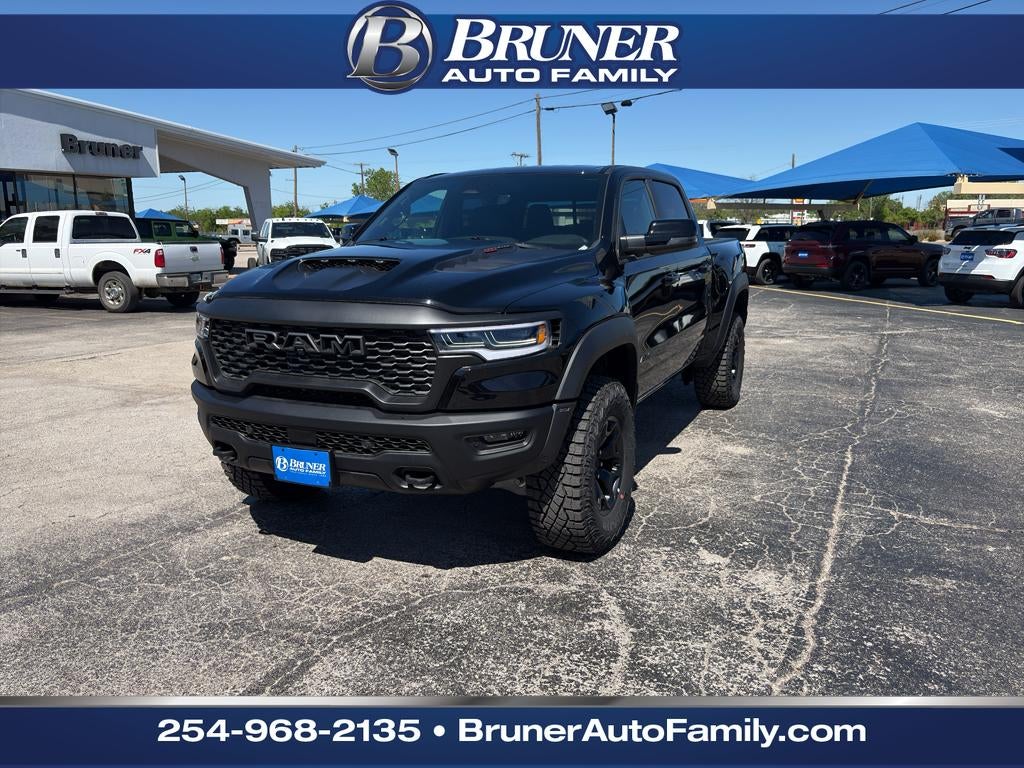 2026 RAM Ram 1500 RAM 1500 RHO CREW CAB 4X4 5'7' BOX in Diamond Black Crystal Pearl-Coat Exterior Paint — front three-quarter view