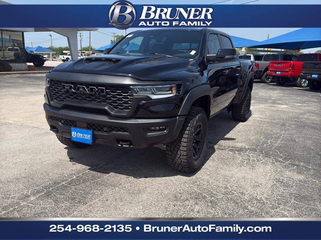 2026 RAM Ram 1500 RAM 1500 RHO CREW CAB 4X4 5'7' BOX in Diamond Black Crystal Pearl-Coat Exterior Paint — front three-quarter view